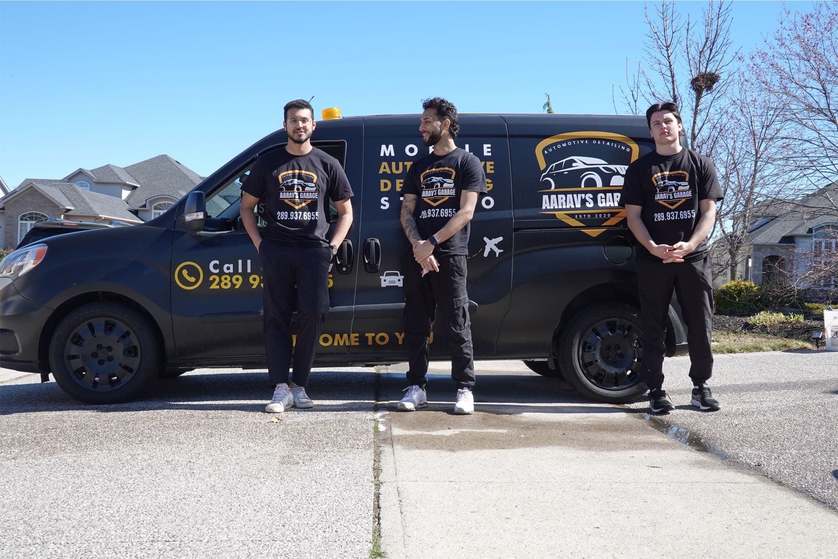 The Aarav's Garage team with their wrapped mobile detailing studio van