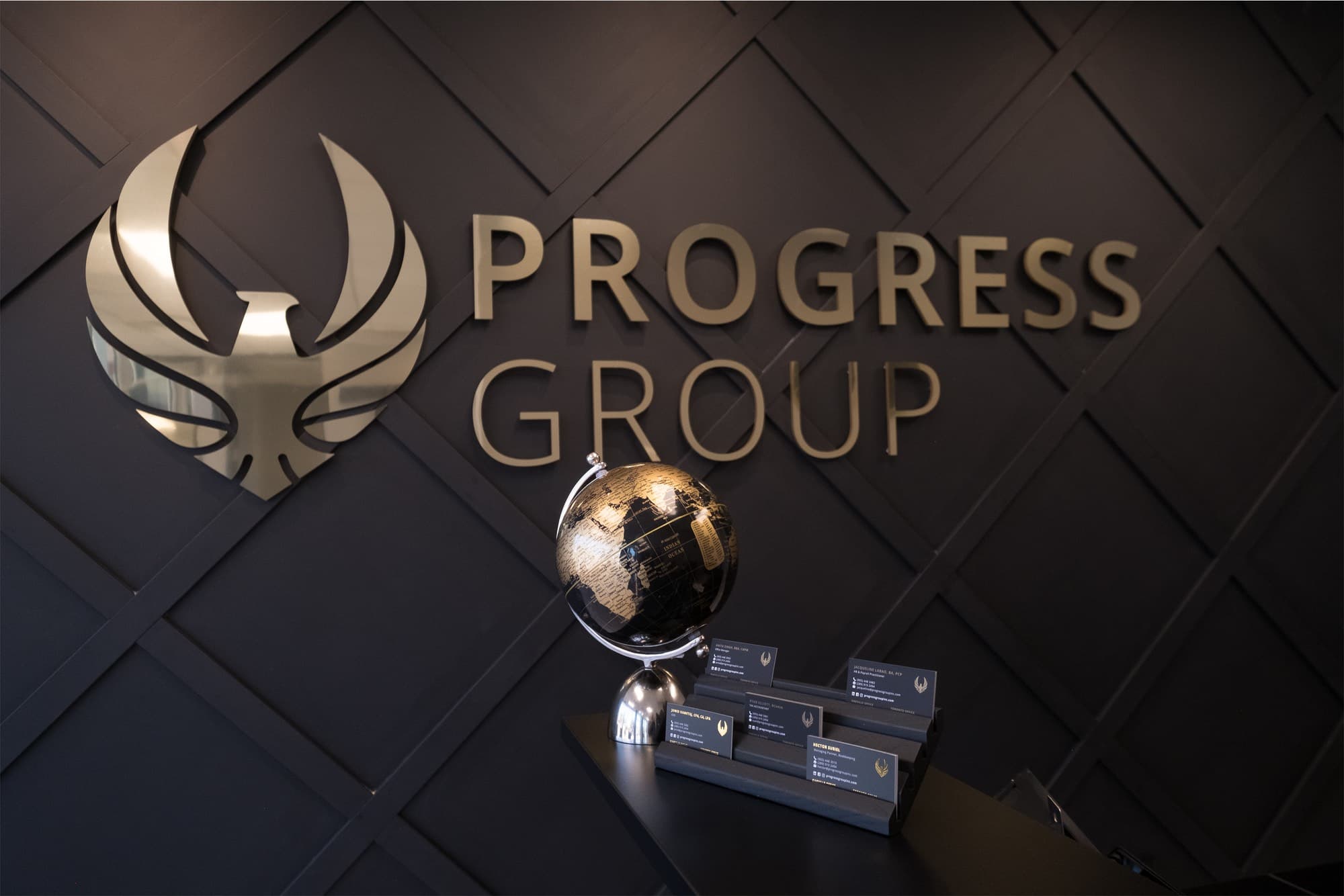 Progress Group's gold eagle logo wall
